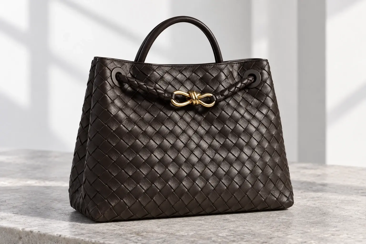 Dark brown Bottega Veneta handbag with woven leather and gold hardware